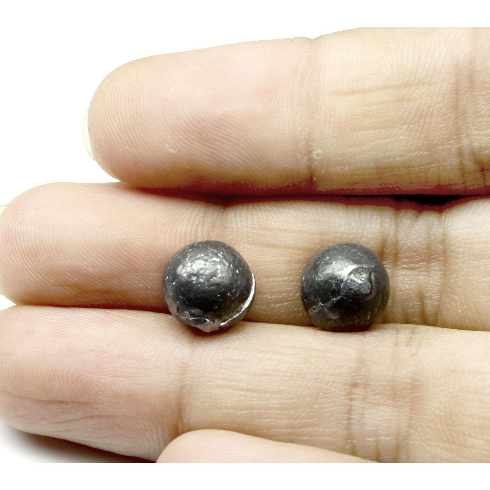 Ranga goli in hands. Lead balls for astrology and lal kitab upay
