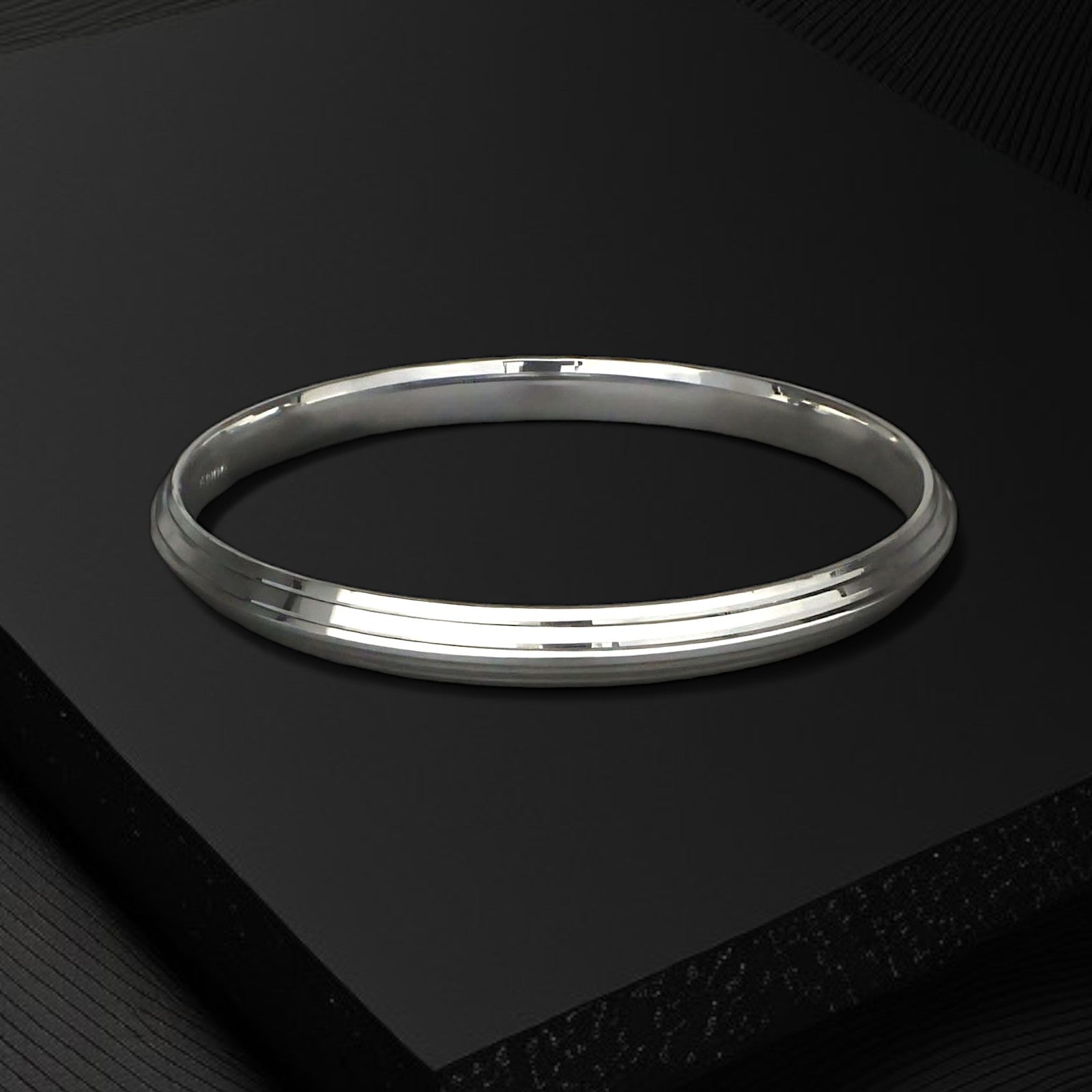 Silver kada for men on a black box