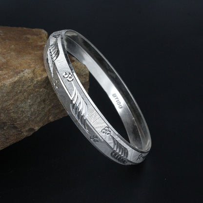 Silver kada for men with engraving on it